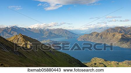 Stock Image - Mountain and lake views from Mount Roy, Roys Peak, Lake Wanaka, Southern Alps, Otago, South Island, New Zealand, Oceania. Fotosearch