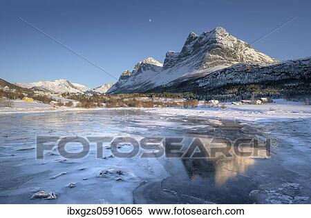 Stock Photography - Mountain massif reflected in ice, frozen fjord, Meløy, Nordland, Norway, Europe. Fotosearch