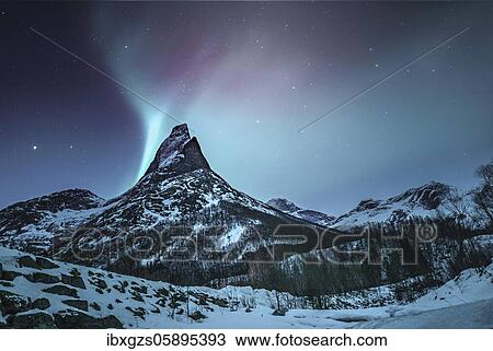 Stock Image - Mountain peak (Aurora borealis) Stetind, arctic winter landscape, night view, starry sky, northern lights Northern Lights, Stetinden, Nordland, Norway, Europe. Fotosearch