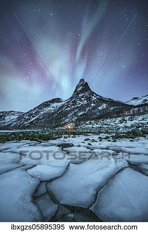 Stock Photography - Mountain peak (Aurora borealis) Stetind, arctic winter landscape, night view, starry sky, northern lights Northern Lights, in front ice floes, Stetinden, Nordland, Norway, Europe. Fotosearch