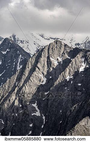 Stock Image - Mountain peaks, snow-covered mountains, dramatic mountain landscape with cloudy skies, Zillertal Alps, Zillertal, Tyrol, Austria, Europe. Fotosearch