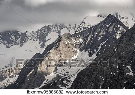 Mountain peaks, snow-covered mountains, dramatic mountain landscape with cloudy skies, Zillertal Alps, Zillertal, Tyrol, Austria, Europe View Large Photo Image Stock Image - Mountain peaks, snow-covered mountains, dramatic mountain landscape with cloudy skies, Zillertal Alps, Zillertal, Tyrol, Austria, Europe. Fotosearch