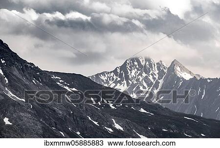 Stock Image - Mountain peaks, snow-covered mountains, dramatic mountain landscape with cloudy skies, Zillertal Alps, Zillertal, Tyrol, Austria, Europe. Fotosearch