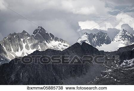 Stock Photo - Mountain peaks, snow-covered mountains, dramatic mountain landscape with cloudy skies, Zillertal Alps, Zillertal, Tyrol, Austria, Europe. Fotosearch