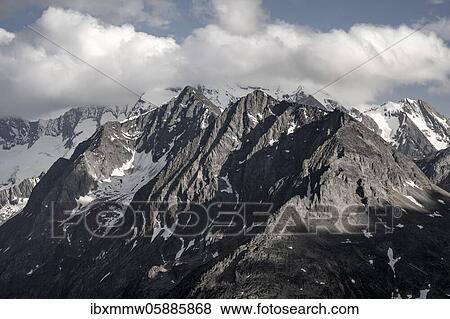 Stock Photo - Mountain peaks, snow-covered mountains, dramatic mountain landscape with cloudy skies, Zillertal Alps, Zillertal, Tyrol, Austria, Europe. Fotosearch