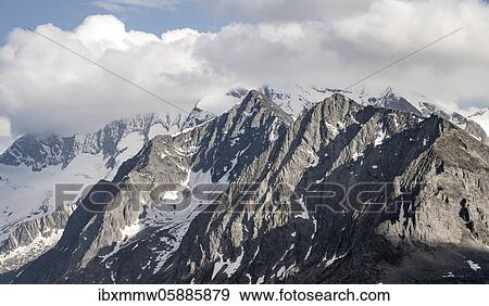Mountain peaks, snow-covered mountains, dramatic mountain landscape with cloudy skies, Zillertal Alps, Zillertal, Tyrol, Austria, Europe View Large Photo Image Stock Photo - Mountain peaks, snow-covered mountains, dramatic mountain landscape with cloudy skies, Zillertal Alps, Zillertal, Tyrol, Austria, Europe. Fotosearch