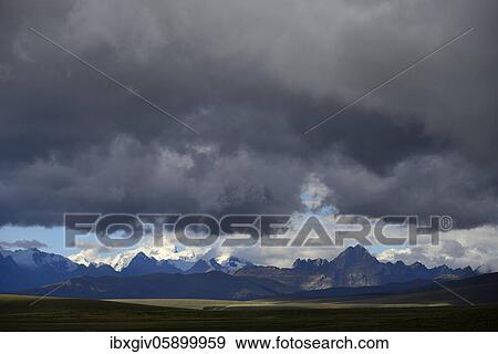 Stock Photo - Mountain range of the Cordillera Blanca under dark clouds, Ruta 110, near Chavín de Huántar, Ancash region, Peru, South America. Fotosearch