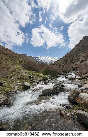 Mountain stream Rio Valdeinfierno, hiking trail near Junta de los Rios, behind Sierra Nevada with summits Mulhacén and La Alcazaba, snow-covered mountains near Granada, Andalusia, Spain, Europe View Large Photo Image Stock Image - Mountain stream Rio Valdeinfierno, hiking trail near Junta de los Rios, behind Sierra Nevada with summits Mulhacén and La Alcazaba, snow-covered mountains near Granada, Andalusia, Spain, Europe. Fotosearch