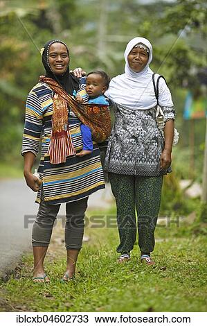 Muslim women, 37 and 45 years old, with toddler in sling, Losari Village, Magelang, Java, Indonesia, Asia View Large Photo Image Stock Image - Muslim women, 37 and 45 years old, with toddler in sling, Losari Village, Magelang, Java, Indonesia, Asia. Fotosearch