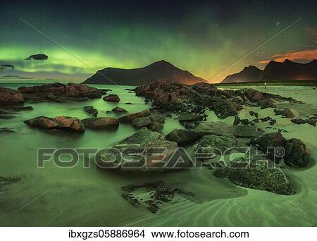 Northern lights over rocky beach, in the back tiny photographer with tripod, Leknes, Nordland, Lofoten, Norway, Europe View Large Photo Image Picture - Northern lights over rocky beach, in the back tiny photographer with tripod, Leknes, Nordland, Lofoten, Norway, Europe. Fotosearch