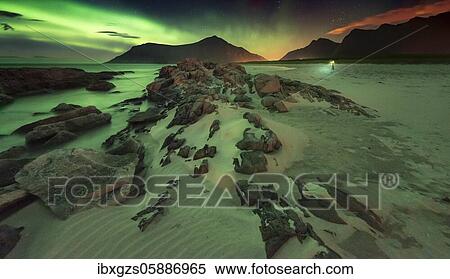 Northern lights over rocky beach, in the back tiny photographer with tripod, Leknes, Nordland, Lofoten, Norway, Europe View Large Photo Image Stock Photography - Northern lights over rocky beach, in the back tiny photographer with tripod, Leknes, Nordland, Lofoten, Norway, Europe. Fotosearch