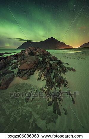Stock Photo - Northern lights over rocky sand beach, Leknes, Nordland, Lofoten, Norway, Europe. Fotosearch