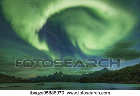 Northern lights over the fjord, behind them rugged peaks of the mountain range Trolltindan, Digermulen, Nordland, Lofoten, Norway, Europe View Large Photo Image Stock Image - Northern lights over the fjord, behind them rugged peaks of the mountain range Trolltindan, Digermulen, Nordland, Lofoten, Norway, Europe. Fotosearch
