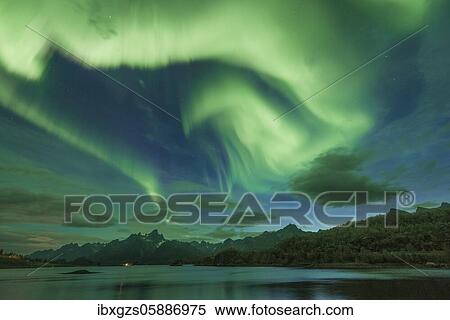 Northern lights over the fjord, behind them rugged peaks of the mountain range Trolltindan, Digermulen, Nordland, Lofoten, Norway, Europe View Large Photo Image Stock Photography - Northern lights over the fjord, behind them rugged peaks of the mountain range Trolltindan, Digermulen, Nordland, Lofoten, Norway, Europe. Fotosearch
