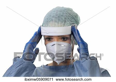 Stock Image - Nurse, medical staff overworked, gestures, hands over head, corona crisis, Baden-Württemberg, Germany, Europe. Fotosearch