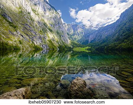 Obersee, in the background the Hagengebirge and the Röth waterfall, Schönau am Königssee, Berchtesgaden National Park, Berchtesgadener Land, Upper Bavaria, Bavaria, Germany, Europe View Large Photo Image Stock Image - Obersee, in the background the Hagengebirge and the Röth waterfall, Schönau am Königssee, Berchtesgaden National Park, Berchtesgadener Land, Upper Bavaria, Bavaria, Germany, Europe. Fotosearch