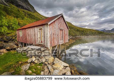 Stock Photo - Old fishing cottage on wooden stilts by the fjord, Fredvang, Lofoten, Nordland, Norway, Europe. Fotosearch