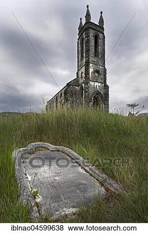 Stock Photo - Old tombstone with decayed church in the background, Dunlewy, County Donegal, Ireland, Europe. Fotosearch