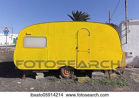 Old, yellow painted caravan, jacked up, Lanzarote, Spain, Europe View Large Photo Image Picture - Old, yellow painted caravan, jacked up, Lanzarote, Spain, Europe. Fotosearch