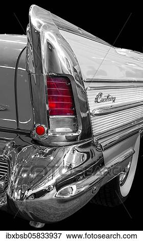 Stock Photo - Oldtimer detail, Buick Century 1958, in black and white, with red brake light. Fotosearch