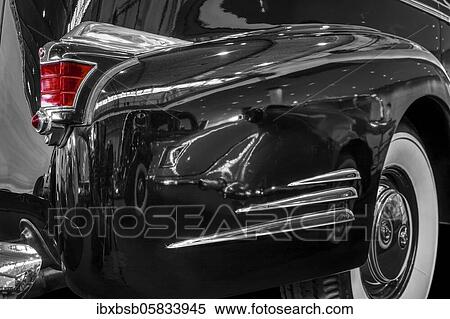 Stock Photography - Oldtimer detail, Cadillac Fleetwood 1938, in black and white, with red brake light. Fotosearch