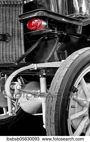 Stock Image - Oldtimer detail, in black and white, with red brake light. Fotosearch