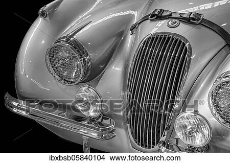 Picture - Oldtimer detail, Jaguar XK 120, in black and white. Fotosearch