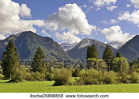 Stock Photo - Panoramic view to the mountains near Oberstdorf, Riefenkopf 1748m and Kegelkopf 1959m, Allgäu Alps, Allgäu, Bavaria, Germany, Europe. Fotosearch