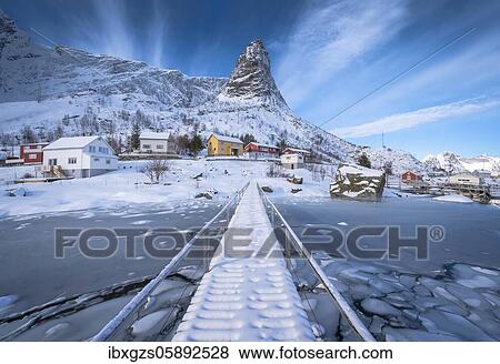 Pedestrian bridge over frozen fjord, in the back residential houses in snowy landscape and mountain formation Hammarskaftet, Nordland, Lofoten, Norway, Europe View Large Photo Image Stock Photo - Pedestrian bridge over frozen fjord, in the back residential houses in snowy landscape and mountain formation Hammarskaftet, Nordland, Lofoten, Norway, Europe. Fotosearch