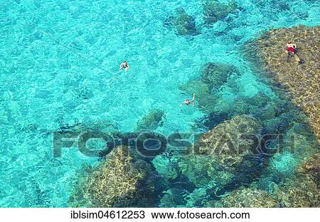 People swimming in the emerald waters of Cala Mitjana, Menorca, Balearic Islands, Spain, Europe View Large Photo Image Stock Image - People swimming in the emerald waters of Cala Mitjana, Menorca, Balearic Islands, Spain, Europe. Fotosearch