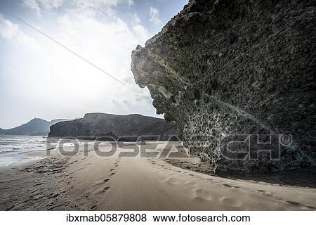 Stock Photo - Petrified lava tongues and rocky coast at the beach Playa del Monsul, Nature Reserve Cabo de Gata-Nijar, Almeria, Andalusia, Spain, Europe. Fotosearch