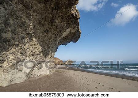 Stock Photo - Petrified lava tongues and rocky coast at the beach Playa del Monsul, Nature Reserve Cabo de Gata-Nijar, Almeria, Andalusia, Spain, Europe. Fotosearch