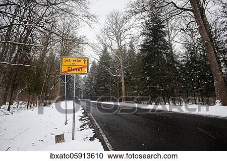 Stock Image - Place name sign at the end of Elend direction Schierke, dreary winter weather, empty country road, district Elend, Oberharz am Brocken, district Harz, Saxony-Anhalt, Germany, Europe. Fotosearch