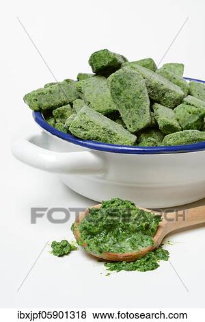 Portioned, frozen creamed spinach in bowl and defrosted spinach in cooking spoon, Germany, Europe View Large Photo Image Stock Photo - Portioned, frozen creamed spinach in bowl and defrosted spinach in cooking spoon, Germany, Europe. Fotosearch