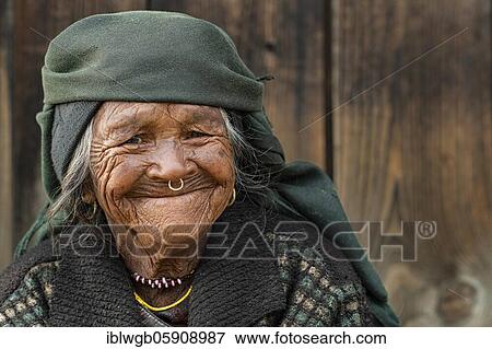 Stock Photo - Portrait, Himalaya, friendly smiling elderly woman with headscarf and nose ring, Jiri, Khumbu region, Nepal, Asia. Fotosearch