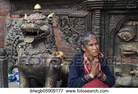Stock Photo - Portrait of a woman, Hindu, in front of Hindu Bairavnath temple, hands folded for the greeting Namaste, Bhaktapur, Kathmandu valley, Nepal, Asia. Fotosearch