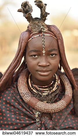 Stock Photo - Portrait of a young, married woman with headdress and necklace, Kaokoveld, Namibia, Africa. Fotosearch