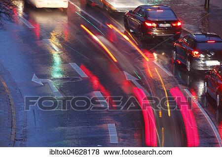 Stock Photo - Rain-wet street, lights, direction arrows in the rain at dusk, Bremen, Germany, Europe. Fotosearch