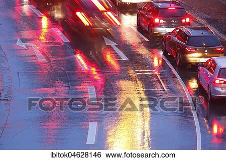 Rain-wet street, lights, direction arrows in the rain at dusk, Bremen, Germany, Europe View Large Photo Image Stock Photograph - Rain-wet street, lights, direction arrows in the rain at dusk, Bremen, Germany, Europe. Fotosearch