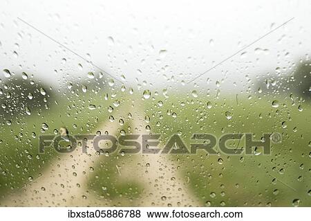 Stock Photo - Raindrops on a car window with field path, Allensbach, Baden-Württemberg, Germany, Europe. Fotosearch