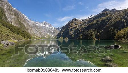 Stock Photography - Reflection in Lake Marian, Fiordland National Park, Te Anau, Southland, South Island, New Zealand, Oceania. Fotosearch