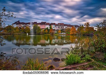 Reflection of the old town of Wil in the pond of the municipal park, thunderclouds at the blue hour, Canton St. Gallen, Switzerland, Europe View Large Photo Image Stock Photograph - Reflection of the old town of Wil in the pond of the municipal park, thunderclouds at the blue hour, Canton St. Gallen, Switzerland, Europe. Fotosearch