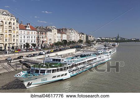 Stock Photograph - River cruise ships on the Danube, back of Liberty Bridge, Pest, Budapest, Hungary, Europe. Fotosearch