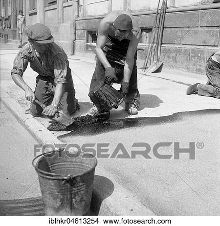 Picture - Road workers tar a road, ca. 1945 to 1955, Freiburg, Germany, Europe. Fotosearch