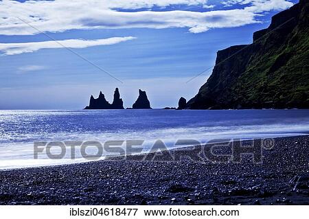 Rock spikes Reynisdrangar with surf on the beach near Vík í Myrdal, South Iceland, Iceland, Europe View Large Photo Image Stock Photo - Rock spikes Reynisdrangar with surf on the beach near Vík í Myrdal, South Iceland, Iceland, Europe. Fotosearch