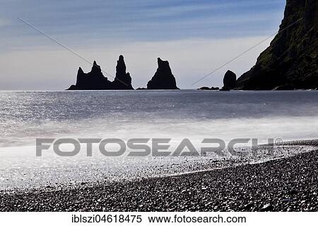 Rock spikes Reynisdrangar with surf on the beach near Vík í Myrdal, South Iceland, Iceland, Europe View Large Photo Image Stock Photography - Rock spikes Reynisdrangar with surf on the beach near Vík í Myrdal, South Iceland, Iceland, Europe. Fotosearch
