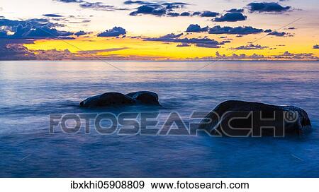 Rocks in the sea, sunset in the bay of Beau Vallon, Mahe Island, Seychelles, Africa View Large Photo Image Stock Photo - Rocks in the sea, sunset in the bay of Beau Vallon, Mahe Island, Seychelles, Africa. Fotosearch