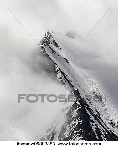 Stock Image - Rugged mountain peaks, degree of the Großer Möseler with glacier Furtschaglkees, snow-covered mountains, high alpine landscape in fog, Berliner Höhenweg, Zillertaler Alps, Zillertal, Tyrol, Austria, Europe. Fotosearch