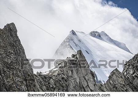 Stock Photo - Rugged mountain peaks, Großer Möseler with Furtschaglkees glacier, snow-covered mountains, high alpine landscape in fog, Berliner Höhenweg, Zillertal Alps, Zillertal, Tyrol, Austria, Europe. Fotosearch