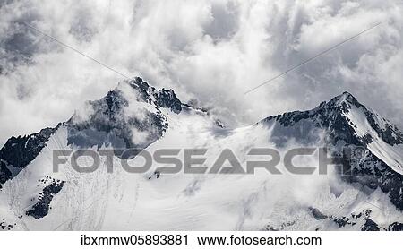 Rugged mountain peaks, left Rossgruspitz, right Großer Möseler, Waxeggkees glacier, snow-covered mountains, high alpine landscape in fog, Berliner Höhenweg, Zillertal Alps, Zillertal, Tyrol, Austria, Europe View Large Photo Image Stock Image - Rugged mountain peaks, left Rossgruspitz, right Großer Möseler, Waxeggkees glacier, snow-covered mountains, high alpine landscape in fog, Berliner Höhenweg, Zillertal Alps, Zillertal, Tyrol, Austria, Europe. Fotosearch